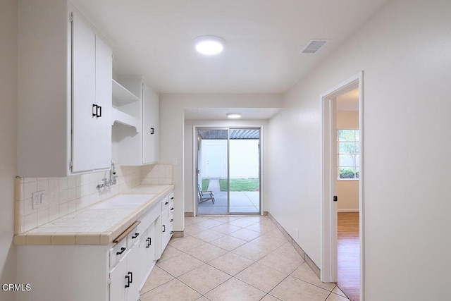 139 Spanner St, Monrovia, CA 91016 - kitchen with open shelves, a sink, white cabinetry, decorative backsplash, and light tile patterned floors
