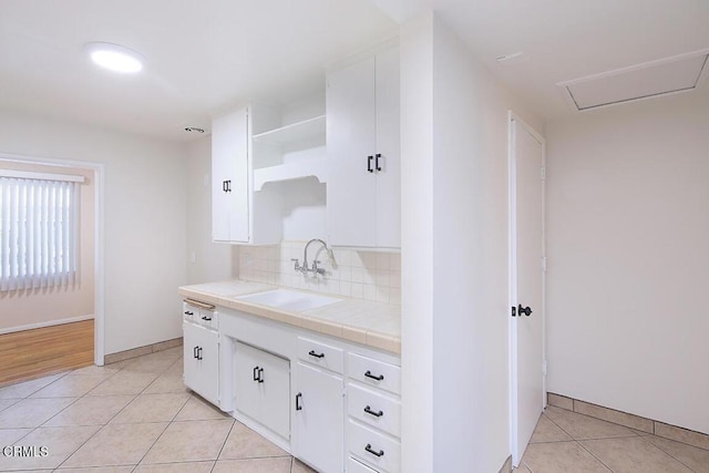 139 Spanner St, Monrovia, CA 91016 - kitchen featuring tile countertops, open shelves, a sink, light tile patterned flooring, and white cabinetry
