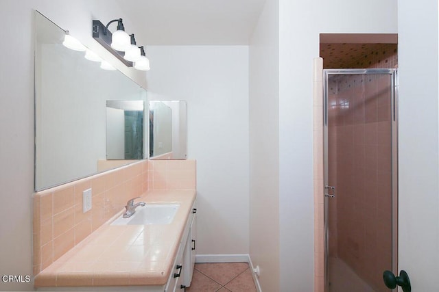139 Spanner St, Monrovia, CA 91016 - bathroom with vanity, a shower stall, tile patterned flooring, backsplash, and baseboards