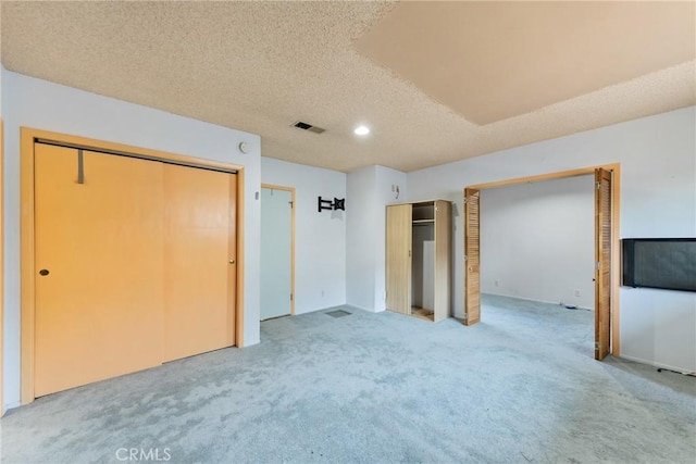 344 E Reed St, Covina, CA 91723 - unfurnished bedroom with two closets, light colored carpet, a textured ceiling, and recessed lighting