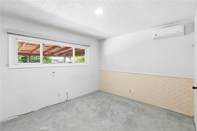 344 E Reed St, Covina, CA 91723 - empty room with a wall mounted AC, carpet, and a textured ceiling