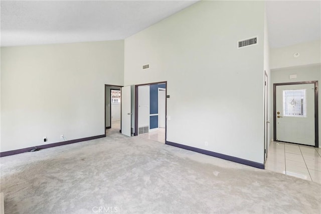 344 E Reed St, Covina, CA 91723 - carpeted empty room with high vaulted ceiling and baseboards