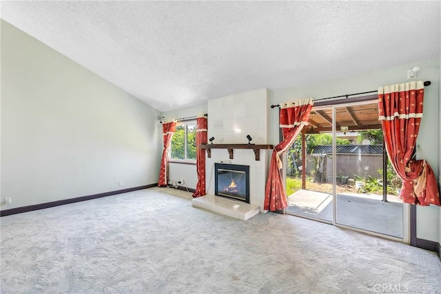 344 E Reed St, Covina, CA 91723 - unfurnished living room with a textured ceiling, carpet flooring, baseboards, and a tile fireplace