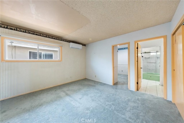 344 E Reed St, Covina, CA 91723 - unfurnished bedroom featuring an AC wall unit, carpet, a textured ceiling, a closet, and ensuite bathroom