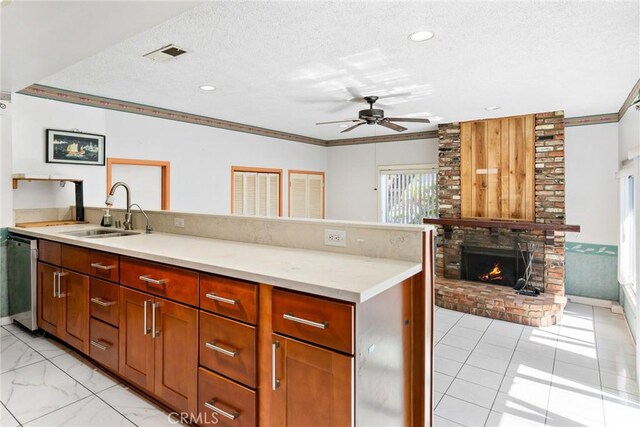 344 E Reed St, Covina, CA 91723 - kitchen featuring a sink, a peninsula, stainless steel dishwasher, a ceiling fan, and a textured ceiling