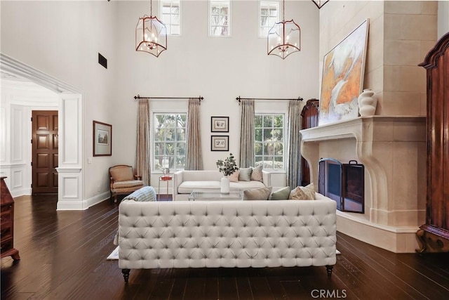 755 Carriage House Dr, Arcadia, CA 91006 - living room with dark wood-style floors, a towering ceiling, a chandelier, and decorative columns
