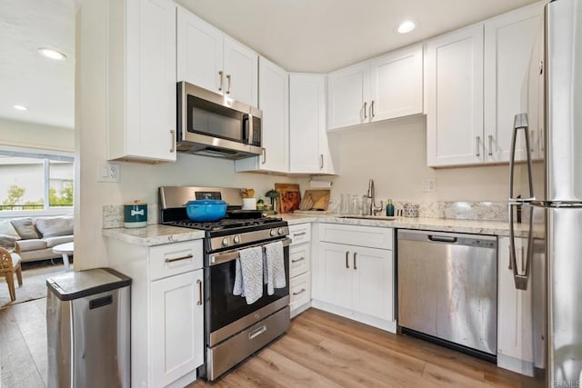 102733 3rd St, Encinitas, CA 92024 - kitchen featuring stainless steel appliances, a sink, light wood-style floors, white cabinets, and recessed lighting