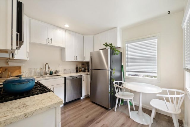102733 3rd St, Encinitas, CA 92024 - kitchen with appliances with stainless steel finishes, a sink, light wood-style floors, white cabinets, and recessed lighting