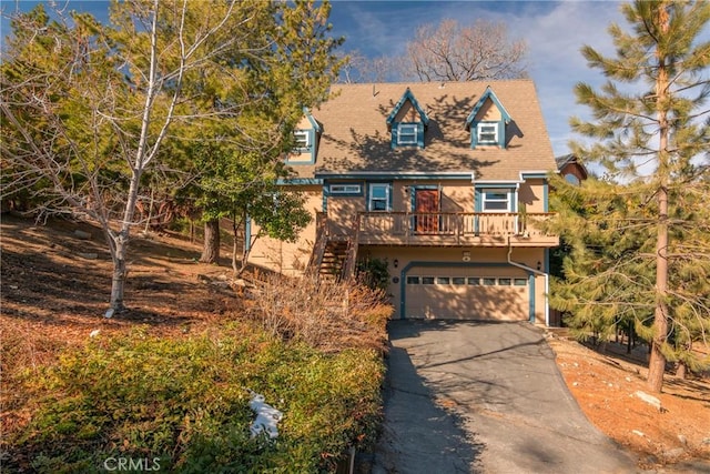 1176 Aleutian Dr, Lake Arrowhead, CA 92352 - view of front of house with a garage, asphalt driveway, stairway, and stucco siding