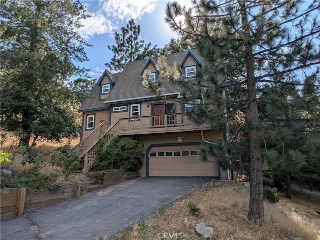 1176 Aleutian Dr, Lake Arrowhead, CA 92352 - view of front of house with asphalt driveway, a garage, and stairs