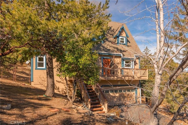 1176 Aleutian Dr, Lake Arrowhead, CA 92352 - view of front of property with a deck, an attached garage, stairs, and a shingled roof