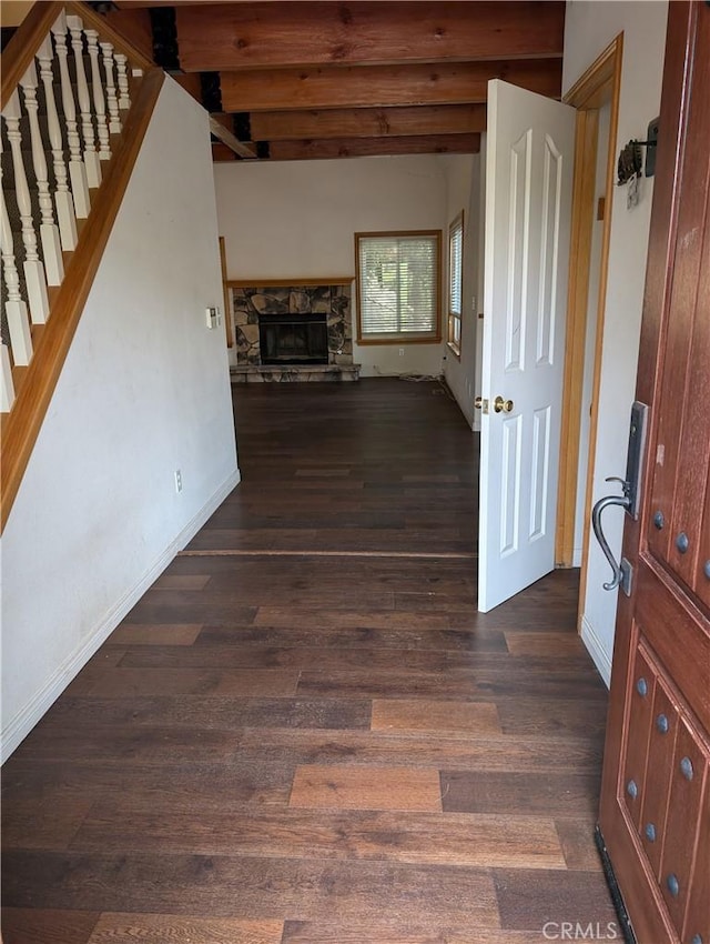 1176 Aleutian Dr, Lake Arrowhead, CA 92352 - unfurnished living room with dark wood-style floors, a stone fireplace, stairway, and beam ceiling
