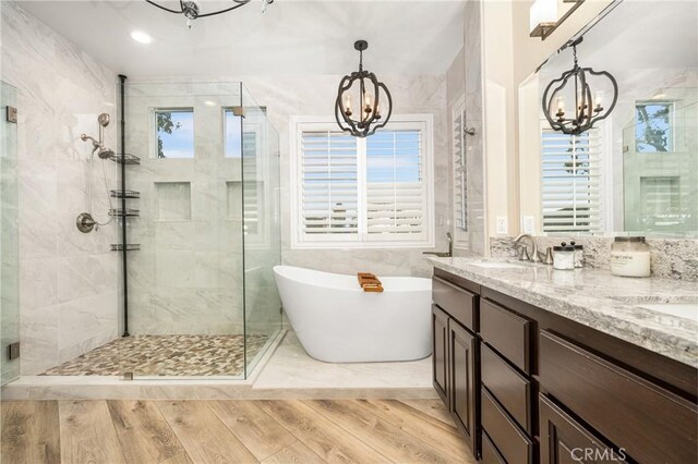 38 Tessera Ave, Lake Forest, CA 92610 - bathroom featuring a chandelier, a stall shower, a freestanding tub, and double vanity