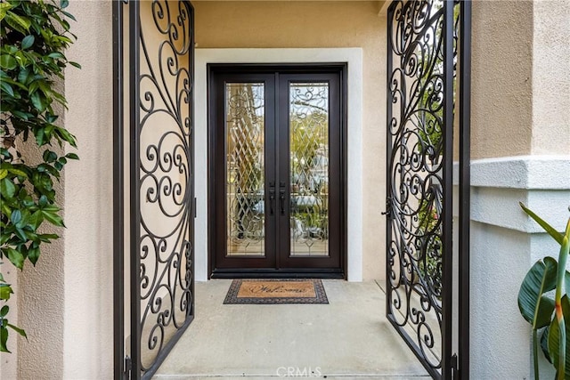 38 Tessera Ave, Lake Forest, CA 92610 - view of exterior entry featuring french doors and stucco siding