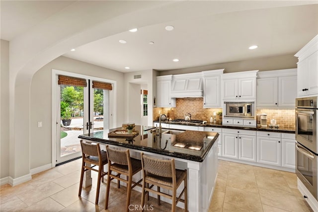 21 Corte Lomas Verdes, San Clemente, CA 92673 - kitchen with stainless steel appliances, a sink, arched walkways, tasteful backsplash, and recessed lighting