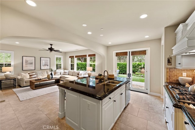 21 Corte Lomas Verdes, San Clemente, CA 92673 - kitchen with a sink, arched walkways, plenty of natural light, recessed lighting, and white cabinetry