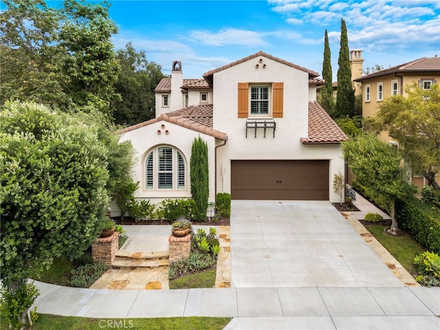 21 Corte Lomas Verdes, San Clemente, CA 92673 - mediterranean / spanish house featuring a tiled roof, stucco siding, concrete driveway, an attached garage, and a chimney