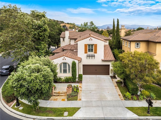 21 Corte Lomas Verdes, San Clemente, CA 92673 - mediterranean / spanish home with a tiled roof, stucco siding, concrete driveway, an attached garage, and a chimney