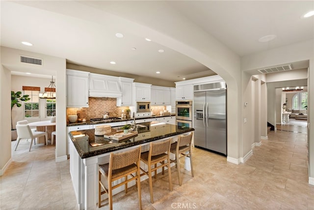 21 Corte Lomas Verdes, San Clemente, CA 92673 - kitchen with built in appliances, healthy amount of natural light, backsplash, white cabinets, and recessed lighting