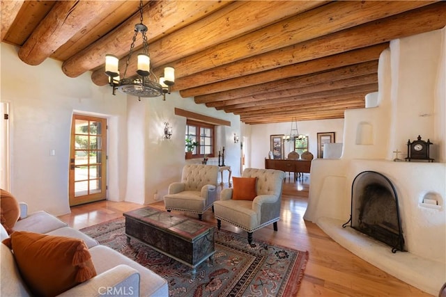1615 Halsey St, Redlands, CA 92373 - living room featuring a chandelier, beam ceiling, plenty of natural light, and wood finished floors