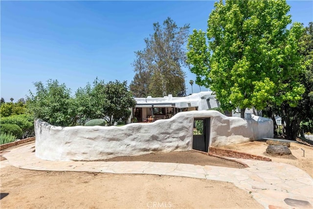 1615 Halsey St, Redlands, CA 92373 - pueblo revival-style home featuring a gate