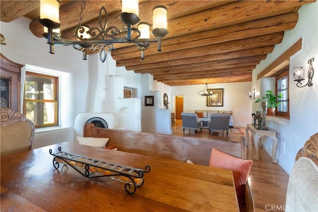 1615 Halsey St, Redlands, CA 92373 - dining room featuring a chandelier, beam ceiling, wood finished floors, and plenty of natural light
