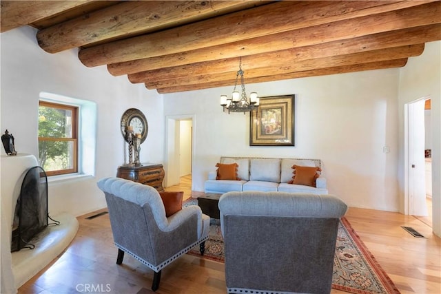 1615 Halsey St, Redlands, CA 92373 - living room with beamed ceiling, light wood-style flooring, and a chandelier