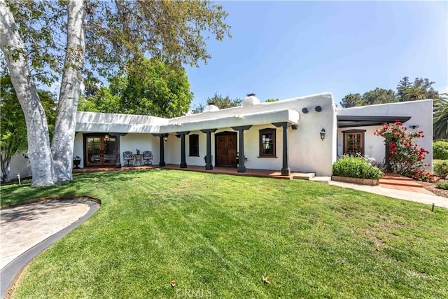 1615 Halsey St, Redlands, CA 92373 - view of front of house featuring a front lawn, french doors, stucco siding, a porch, and a chimney