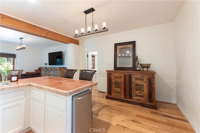1615 Halsey St, Redlands, CA 92373 - kitchen featuring tile countertops, light wood-style flooring, white cabinetry, a chandelier, and hanging light fixtures