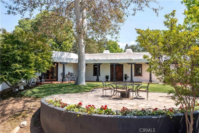 1615 Halsey St, Redlands, CA 92373 - rear view of property with a patio, a yard, stucco siding, and french doors