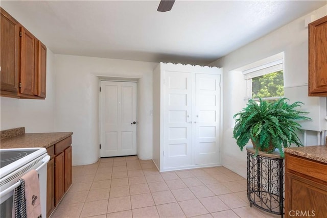 1615 Halsey St, Redlands, CA 92373 - kitchen featuring brown cabinets, electric stove, light tile patterned floors, and ceiling fan