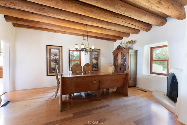 1615 Halsey St, Redlands, CA 92373 - dining area featuring beamed ceiling, light wood finished floors, and a chandelier