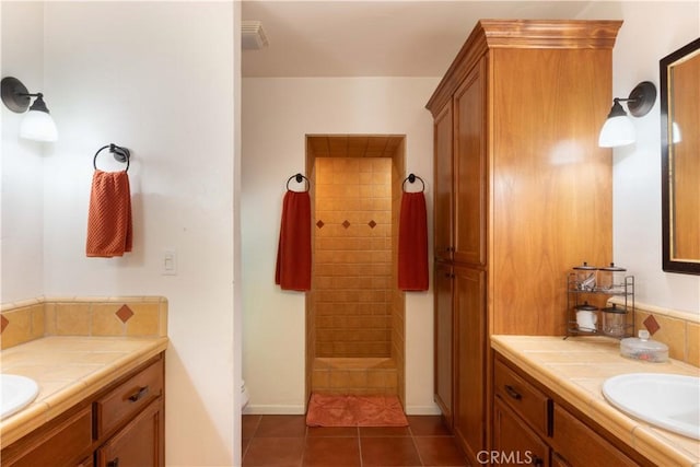 1615 Halsey St, Redlands, CA 92373 - bathroom featuring tiled shower, two vanities, and tile patterned flooring