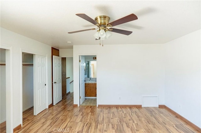 3117 Andre Ln, Turlock, CA 95382 - unfurnished bedroom with light wood-style floors, ensuite bath, multiple closets, and ceiling fan