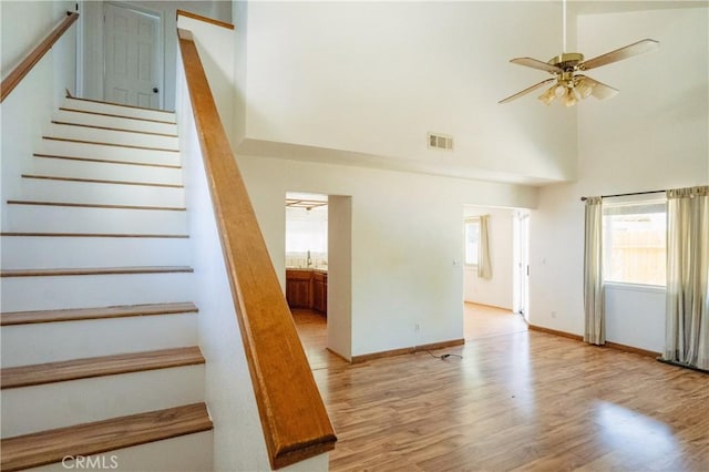 3117 Andre Ln, Turlock, CA 95382 - staircase featuring a towering ceiling, a ceiling fan, and wood finished floors