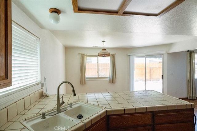 3117 Andre Ln, Turlock, CA 95382 - kitchen featuring a peninsula, tile counters, and decorative light fixtures