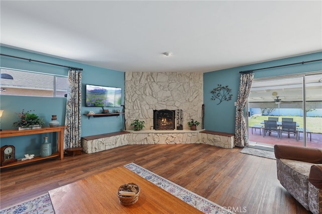 15403 Domart Ave, Norwalk, CA 90650 - living area with a stone fireplace and wood finished floors