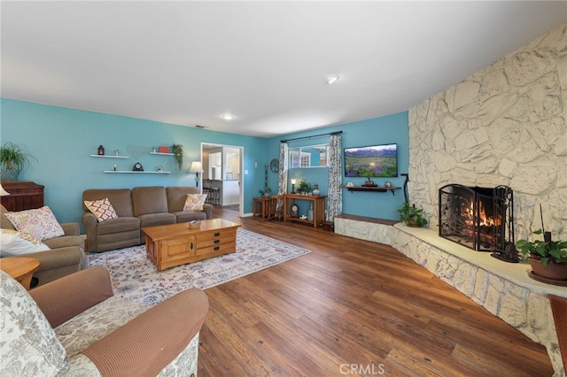 15403 Domart Ave, Norwalk, CA 90650 - living area with wood finished floors and a stone fireplace