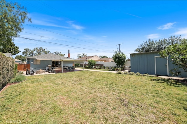15403 Domart Ave, Norwalk, CA 90650 - view of yard featuring a patio area, an outdoor fire pit, and an outdoor structure