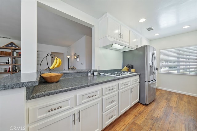 15403 Domart Ave, Norwalk, CA 90650 - kitchen with under cabinet range hood, white gas cooktop, white cabinets, light wood-style floors, and recessed lighting