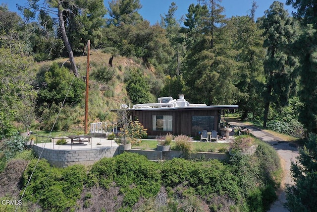 633 Norumbega Dr, Monrovia, CA 91016 - back of property with a patio, a view of trees, and a chimney