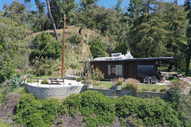633 Norumbega Dr, Monrovia, CA 91016 - back of house with a wooded view and a chimney