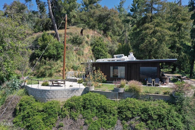 633 Norumbega Dr, Monrovia, CA 91016 - back of house with a wooded view and a chimney