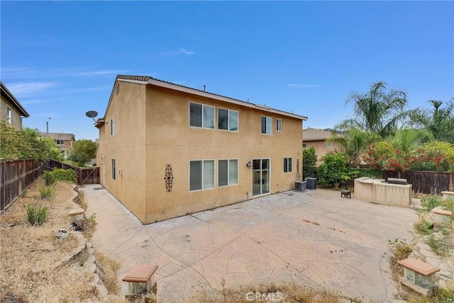 46186 Via Ln, Tranquila, Temecula, CA 92592 - back of house featuring stucco siding, a patio, a fenced backyard, and cooling unit