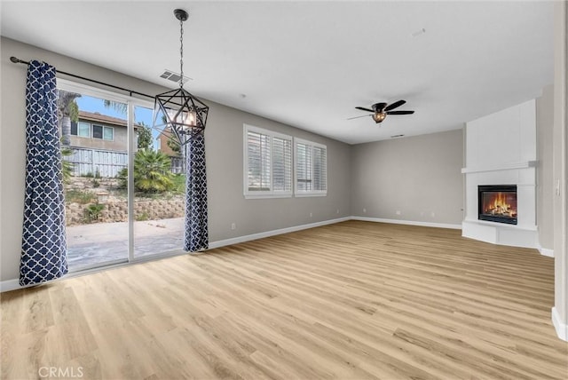 46186 Via Ln, Tranquila, Temecula, CA 92592 - unfurnished living room with light wood-style flooring, ceiling fan, and a fireplace