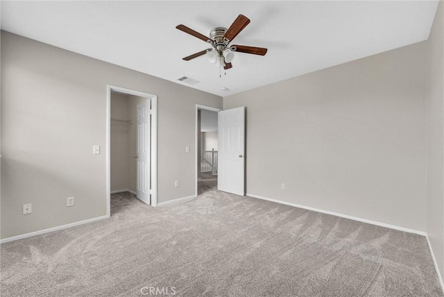 46186 Via Ln, Tranquila, Temecula, CA 92592 - unfurnished bedroom featuring carpet floors, baseboards, a walk in closet, a ceiling fan, and a closet