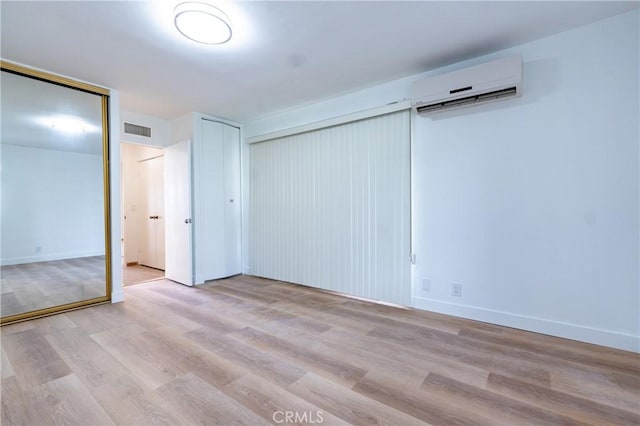 999 E Valley Blvd Unit 114, Alhambra, CA 91801 - unfurnished bedroom featuring a wall unit AC, multiple closets, and wood finished floors