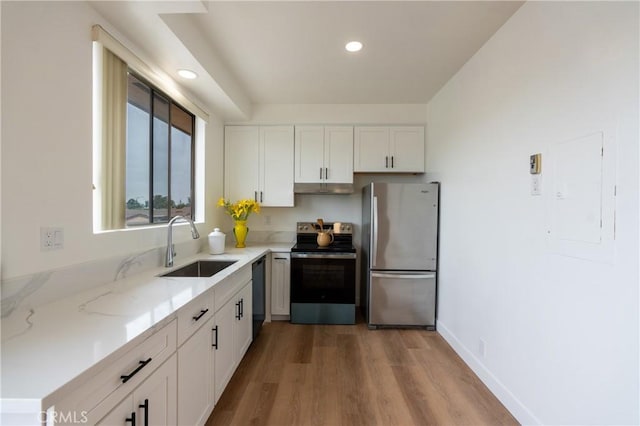 999 E Valley Blvd Unit 114, Alhambra, CA 91801 - kitchen featuring appliances with stainless steel finishes, under cabinet range hood, light stone countertops, white cabinets, and wood finished floors