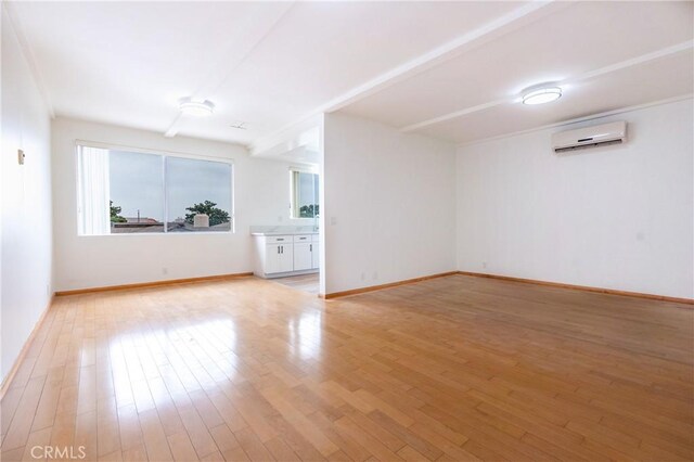 999 E Valley Blvd Unit 114, Alhambra, CA 91801 - empty room featuring a wall unit AC and light wood-style flooring
