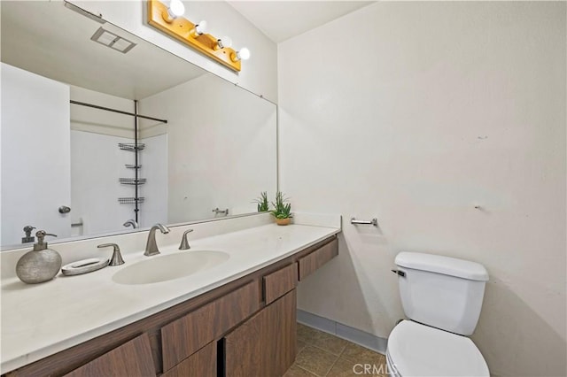 17900 Sherman Way Unit 416, Reseda, CA 91335 - bathroom featuring toilet, vanity, tile patterned flooring, baseboards, and a shower